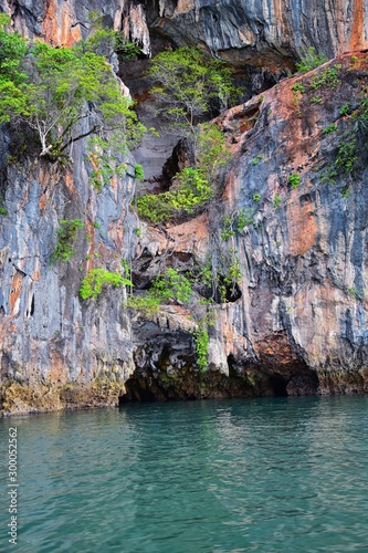 Island, Ocean views near Phuket Thailand with Blues, Turquoise and Greens oceans, mountains, boats, caves, trees resort island of phuket Thailand. Including Phi Phi, Ko Rang Yai, Ko Li Pe and other is