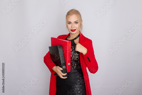 Business woman in jacket holding folders in her hands photo