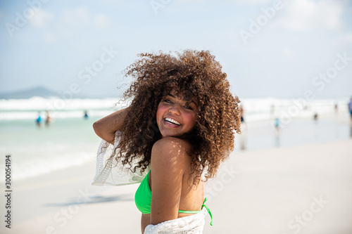 Black afro young cute girl, curly hair, bikini, beach. Afro American summer vacation holiday.
