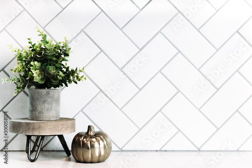 White subway tile background with small minimalist decor 