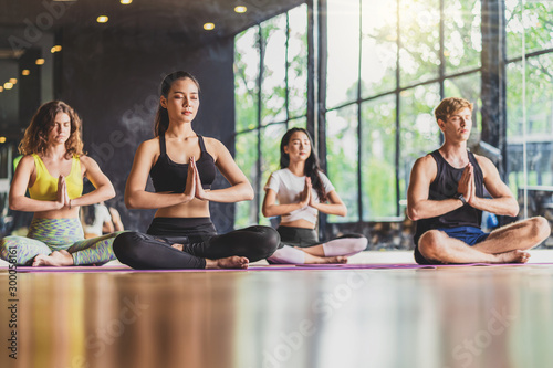 "Group of diversity practicing yoga class, healthy or Meditation Exercise,stretching in upward facing dog exercise, wearing sportswear bra and pants, sports and healthcare concept,."