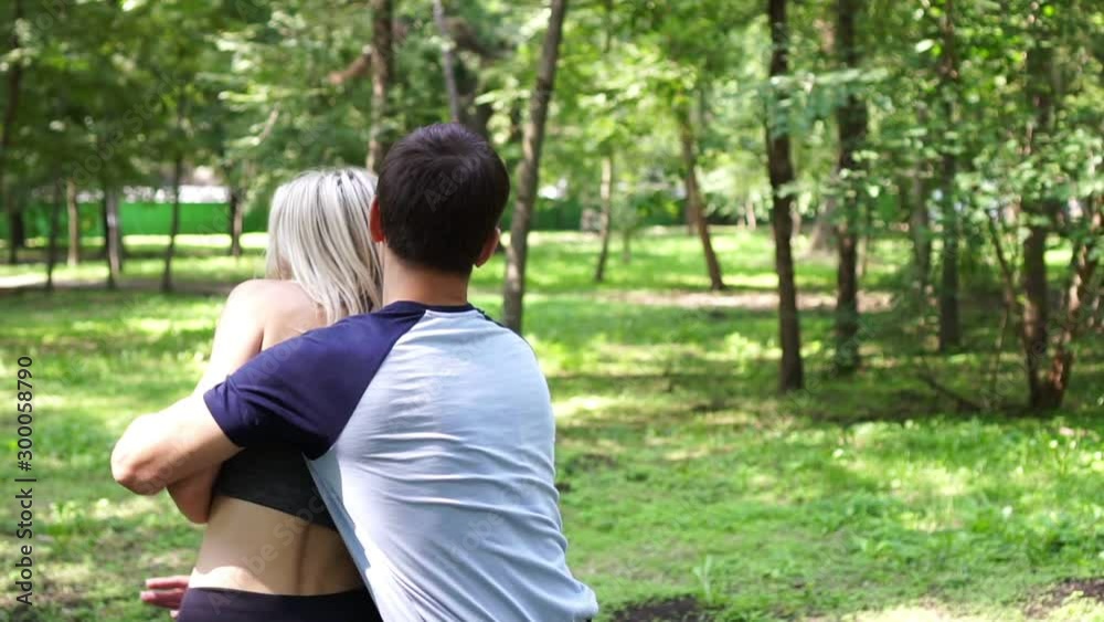 A woman is training in the park, fighting, self-defense, hand-to-hand combat.