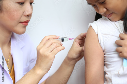 Close-up of doctor making vaccination to the patient on white background,Healthy concept photo