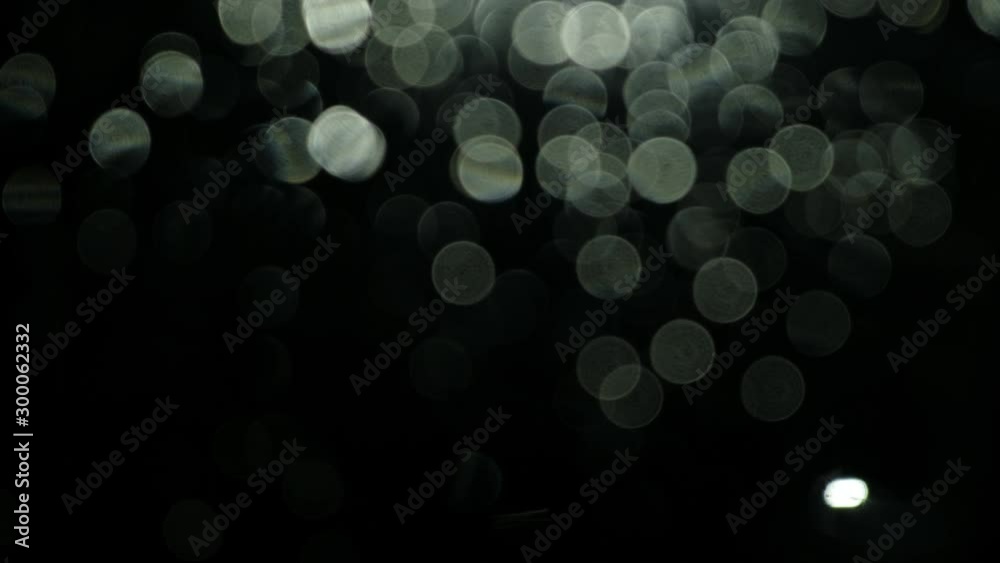 Abstract background with light bokeh on a dark window, dark rainy night concept Abstract background with light bokeh on a dark window, dark rainy night concept