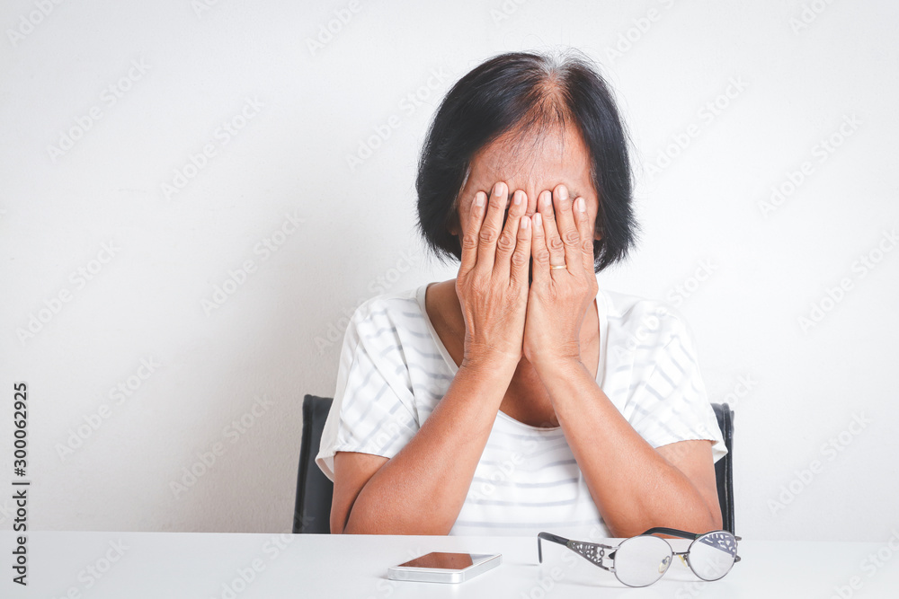 Asian elderly women have stress Feeling very worried about problems with retirement life. White background Asian elderly women have stress Feeling very worried about problems with retirement life. White background