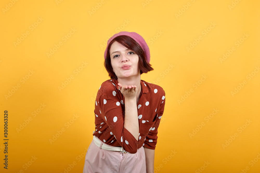 Young beautiful woman wearing funny fashion red shirt looking at the camera  blowing a kiss with hand on air being lovely, sexy. Love expression. Stock  Photo | Adobe Stock