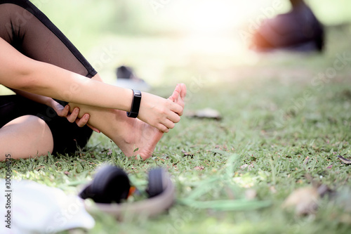 Cropped shot of young woman massaging her painful foot while exercising.