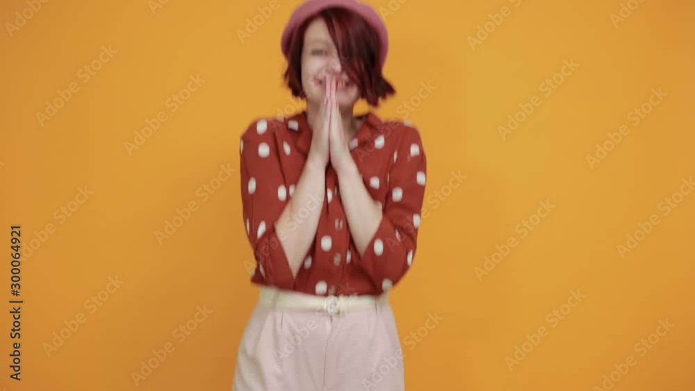Young beautiful brunette woman wearing redshirt in white polka dot over isolated yellow background. Celebrating crazy and amazed for success with arms raised and open eyes screaming excited. Young beautiful brunette woman wearing redshirt in white polka dot over isolated yellow background. Celebrating crazy and amazed for success with arms raised and open eyes screaming excited.