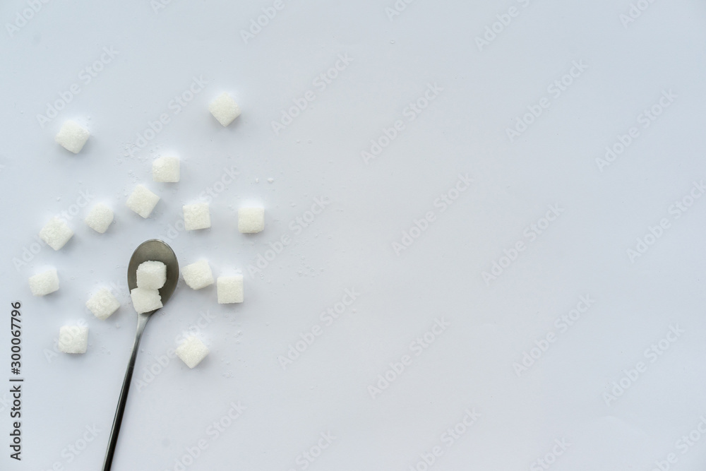 close up top view group of square cube sugar with stainless steel (tablespoon) on white background for food and drink and diabetes concept close up top view group of square cube sugar with stainless steel (tablespoon) on white background for food and drink and diabetes concept