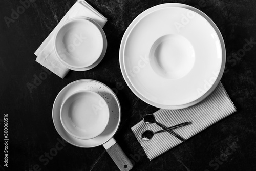 Dinner set on a dark background, Empty white plate with  Fork and Spoon