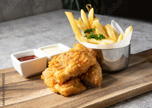 Traditional British Fish and Chips with french fries photo