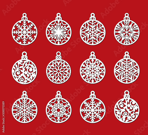 Big set of laser cutting template of Christmas balls with snowflakes. Xmas tree decoration for paper cut out. Silhouette of openwork spheres with lace ornament. Vector illustration on red background.