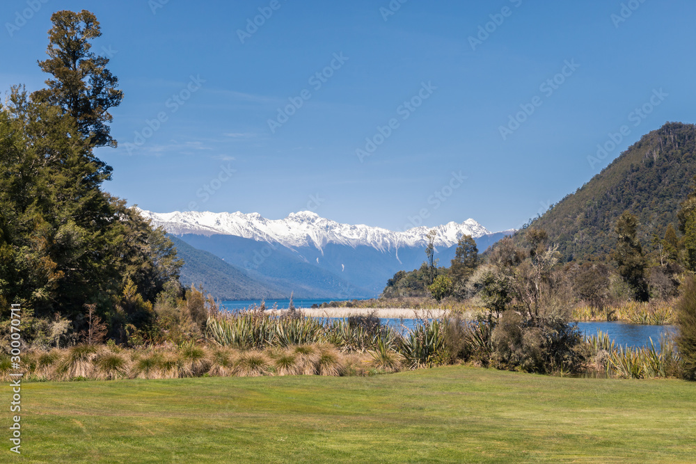 Lake Rotoroa with snow covered mountain range in Nelson Lakes National Park, Southern Alps, New Zealand