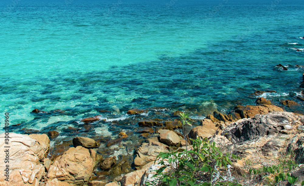 Beautiful beaches with big brown rocks and tree islands in Thailand.