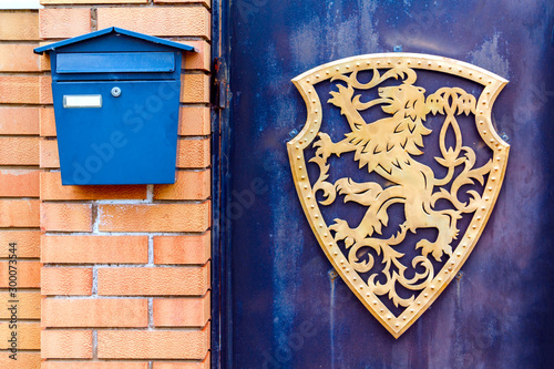 A beautiful mailbox hangs waiting for newspapers, parcels and letters.