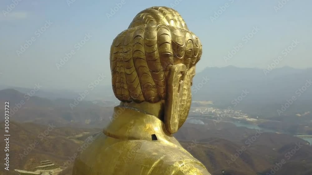 View from the side of Spring Temple Buddha and the temple at it's feet in Lushan County, Henan, China (aerial photography)
