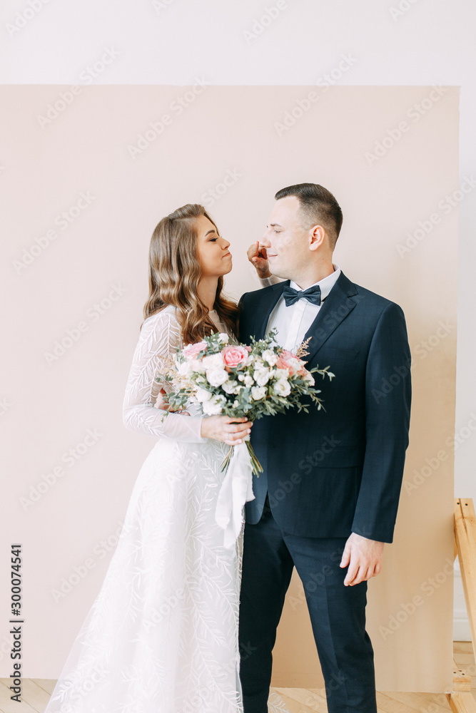 Stylish ceremony in European style. Beautiful couple in the interior Studio.