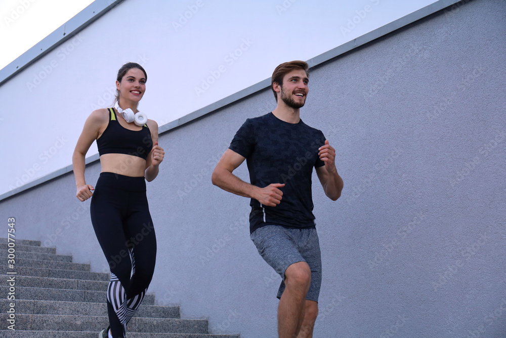 Runner athletes running on stairs. Couple fitness is jogging oudoors. Runner athletes running on stairs. Couple fitness is jogging oudoors.