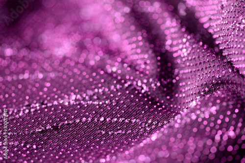 Purple color textile with sparkles close up. Fabric background