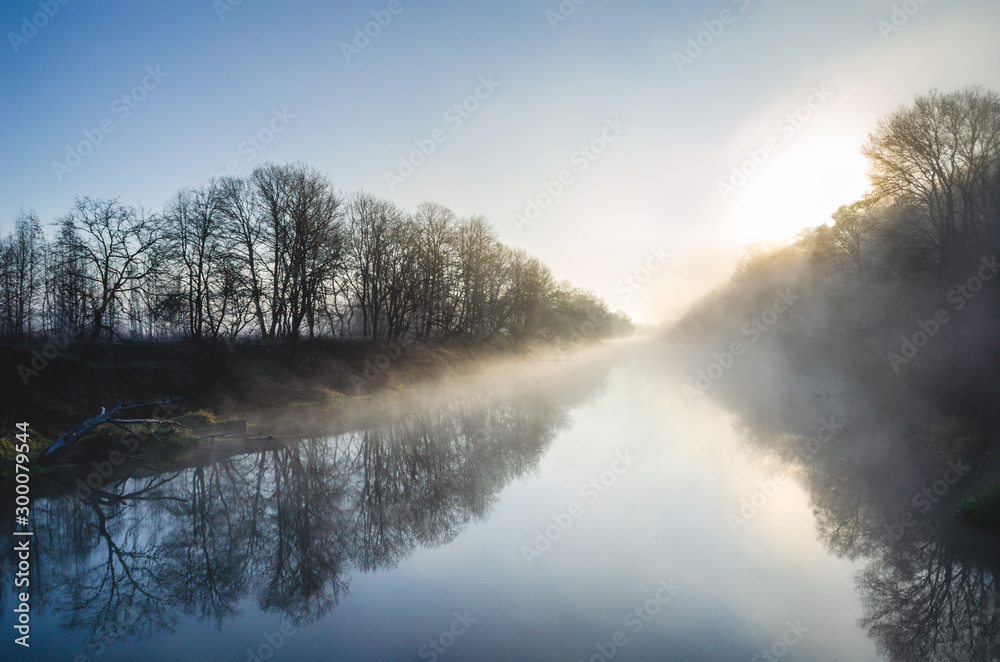 Fototapeta premium Mist rising over an autumn river at dawn. Autumn mist. River Desna, Russia.
