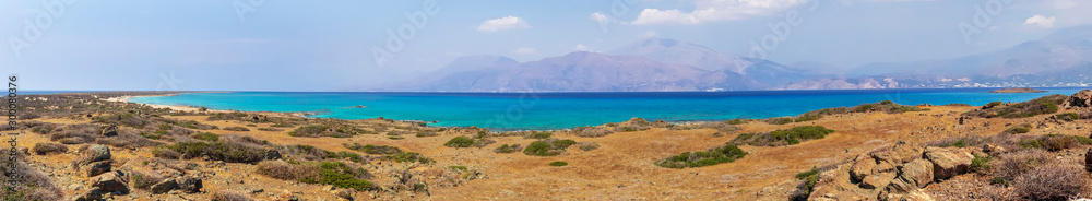 amazing panorama from a desert to a nice gulf , beach , rocks and deep azure sea and high mountains and blue sky on the background. Greek landscape. amazing panorama from a desert to a nice gulf , beach , rocks and deep azure sea and high mountains and blue sky on the background. Greek landscape.
