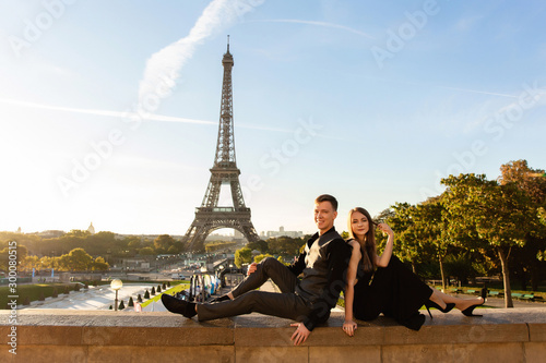 Portrait of happy couple near Eiffel tower in Paris, France