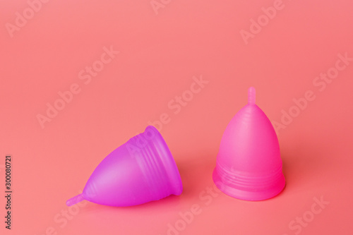 Menstrual cups on pink background. Alternative feminine hygiene product during the period. Women health concept. Copy space. Eco friendly concept, zero waste product. mockup, template