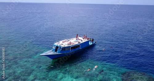 Aerial, Tourists Swimming Near The Yacht In The Open Sea. Maldives photo