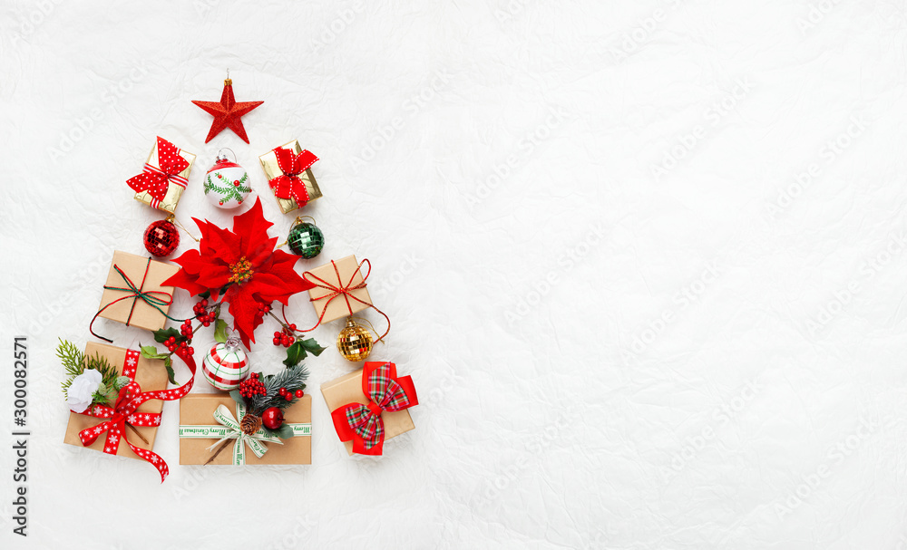 Christmas tree made from Christmas gifts and decorations on white background. Creative winter holiday concept. Flat lay. Christmas tree made from Christmas gifts and decorations on white background. Creative winter holiday concept. Flat lay.