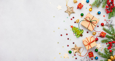 Christmas background with gift boxes, festive decor, fir tree branches and paper cards notes. Flat lay.