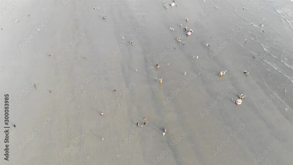 Sea View - Top Aerial View Of Visitors Playing On The Beach And Waves At The Beach Side - Forwards Sea View - Top Aerial View Of Visitors Playing On The Beach And Waves At The Beach Side - Forwards