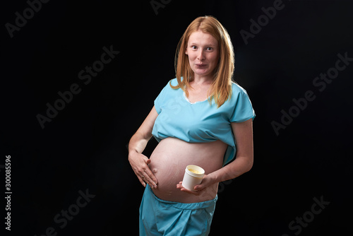 happy pregnant woman with belly cream. prevention of stretch marks. Pregnancy and skin care. belly of pregnant woman and smile from moisturizing cream for stretch marks