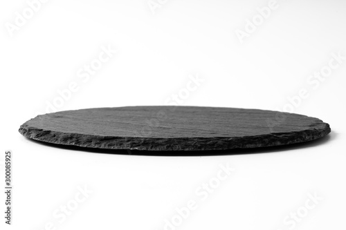 Black round stone plate isolated on white