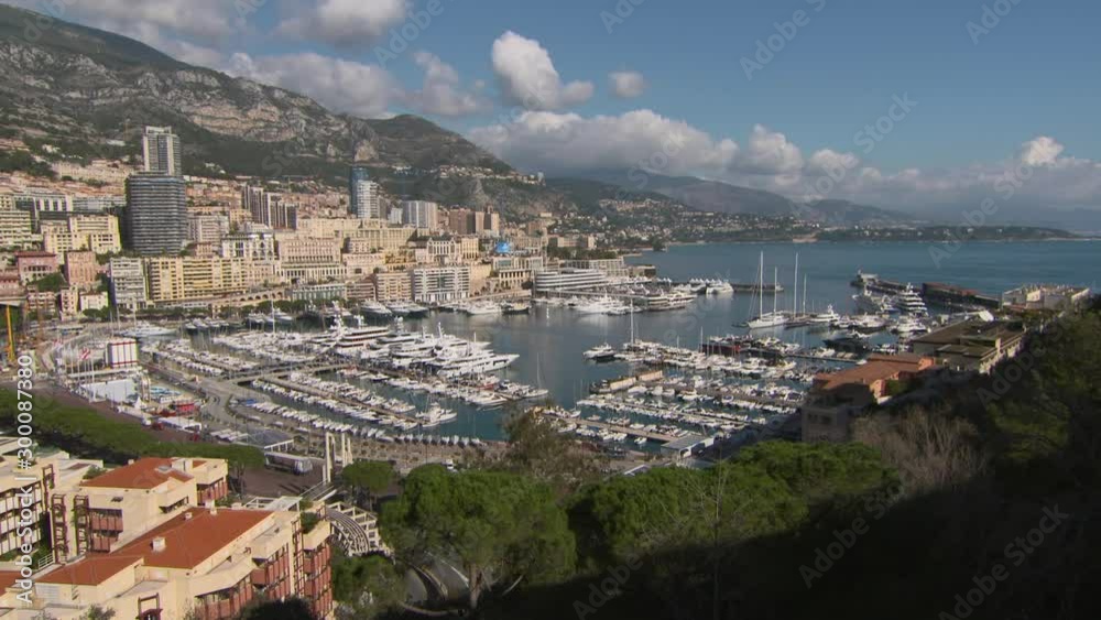 Tourists in city overlooking at famous Port Hercules in sea against sky - Monte Carlo, Monaco Tourists in city overlooking at famous Port Hercules in sea against sky - Monte Carlo, Monaco