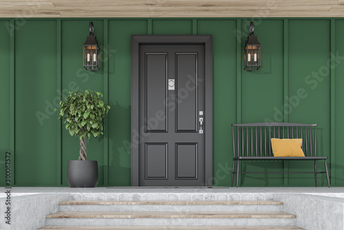 Black front door of green house, tree and bench