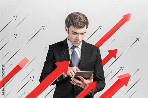 Businessman with tablet, growth concept