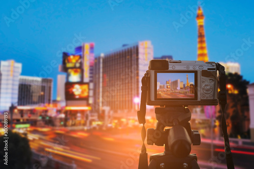 Photography Set the digital camera on a tripod to record the light of the lights from the building and the lights of the cars in the city at twilight