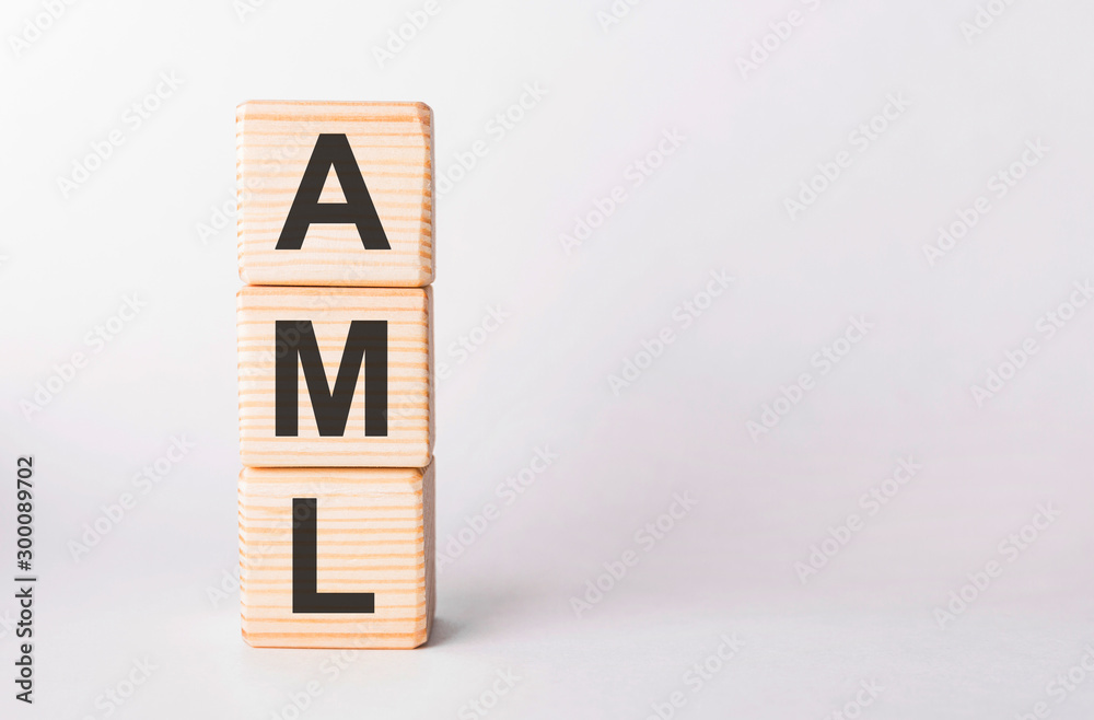 AML letters of wooden blocks in pillar form on white background, copy space AML letters of wooden blocks in pillar form on white background, copy space