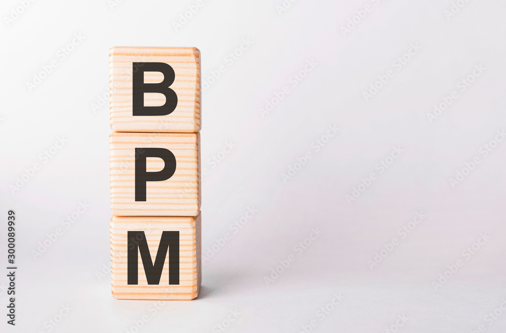 BPM letters of wooden blocks in pillar form on white background, copy space BPM letters of wooden blocks in pillar form on white background, copy space