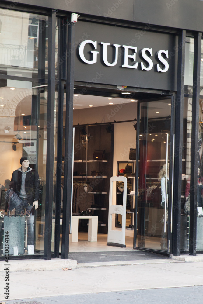 Guess store logo sign American upscale clothing line brand shop