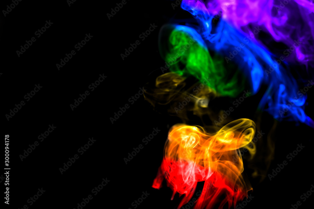 Fototapeta premium Colorful smoke on dark background.