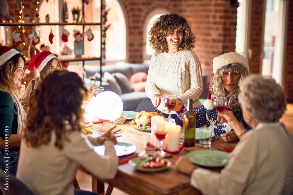 Beautiful group of women smiling happy and confident. Carving roasted turkey celebrating christmas at home Beautiful group of women smiling happy and confident. Carving roasted turkey celebrating christmas at home