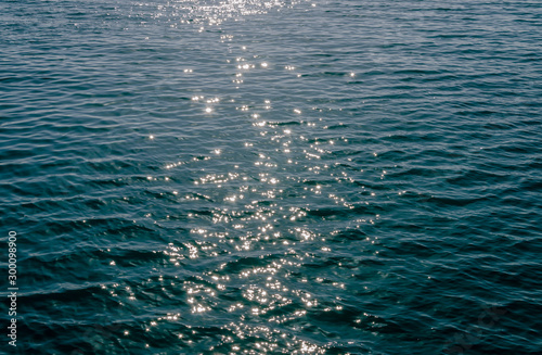 surface of sea water, sun glare on the sea surface on a warm summer day