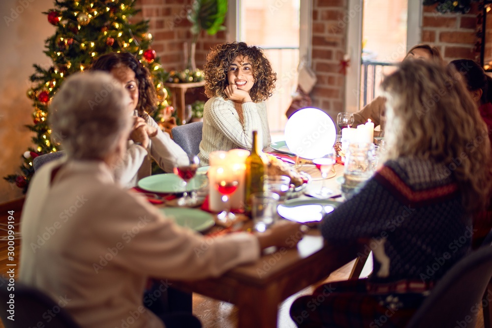 Beautiful group of women smiling happy and confident. Eating roasted turkey celebrating christmas at home Beautiful group of women smiling happy and confident. Eating roasted turkey celebrating christmas at home