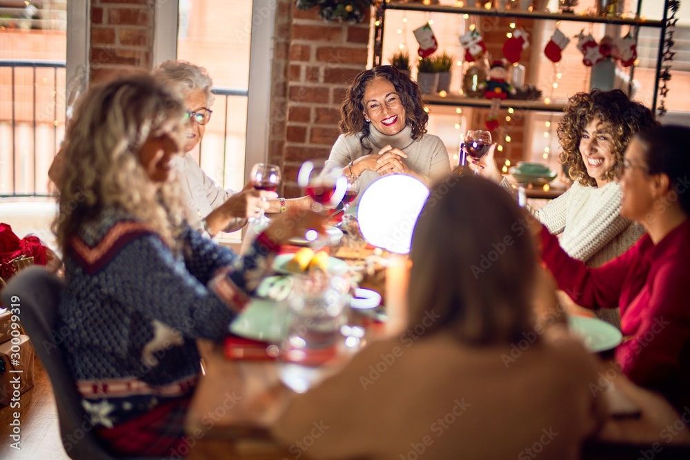 Beautiful group of women smiling happy and confident. Eating roasted turkey celebrating christmas at home Beautiful group of women smiling happy and confident. Eating roasted turkey celebrating christmas at home