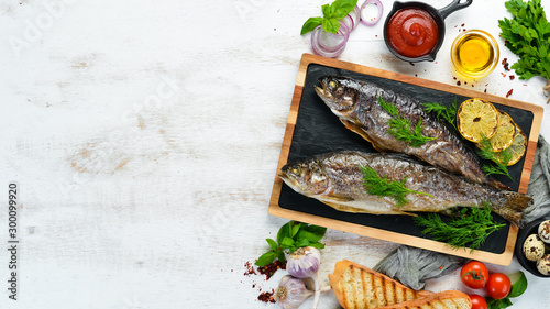 Baked trout on a stone board. Flat lay. Top view. Free copy space.