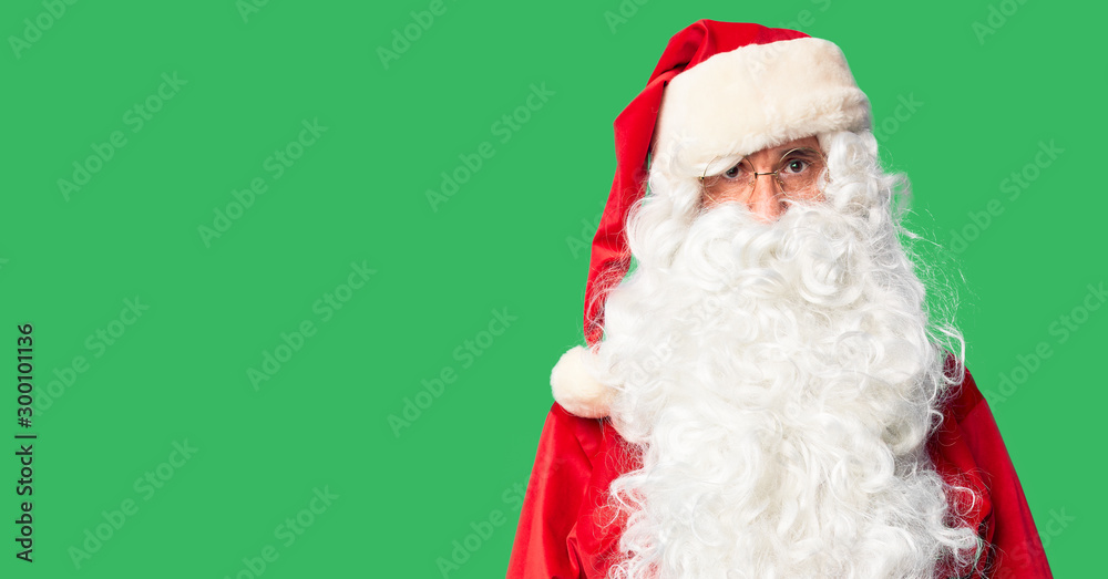 Middle age handsome man wearing Santa Claus costume and beard standing skeptic and nervous, frowning upset because of problem. Negative person.