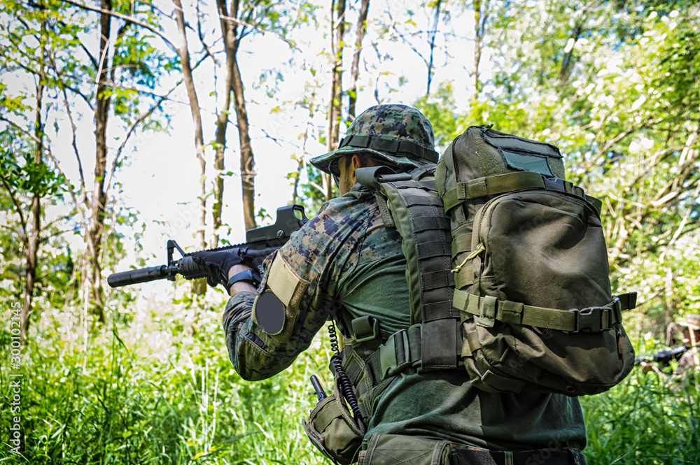 Soldier on the battlefield aiming with his gun