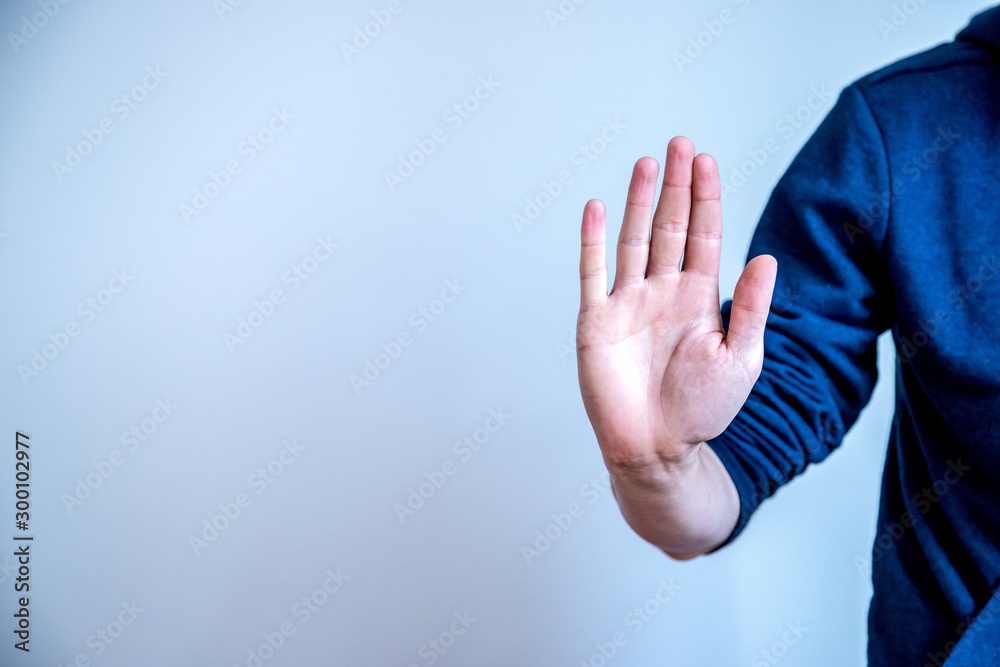 Defense or stop gesture: Male hand with stop gesture - obrazy, fototapety, plakaty 