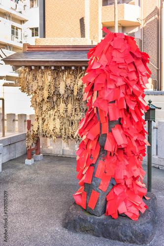 Statue of the Buddhist deity Akagami Nio covered with red papers deposited by the faithful to purify and heal the sick parts of their body in the Japanese temple Togakuji in Tokyo. photo
